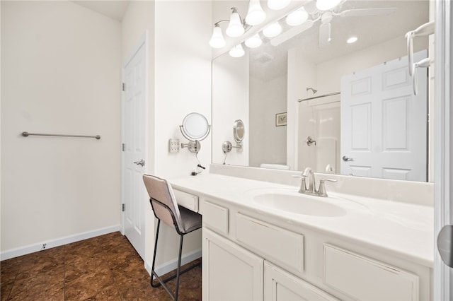 bathroom with vanity, ceiling fan, and walk in shower