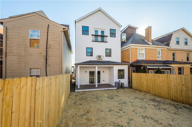 back of house with a patio and central air condition unit