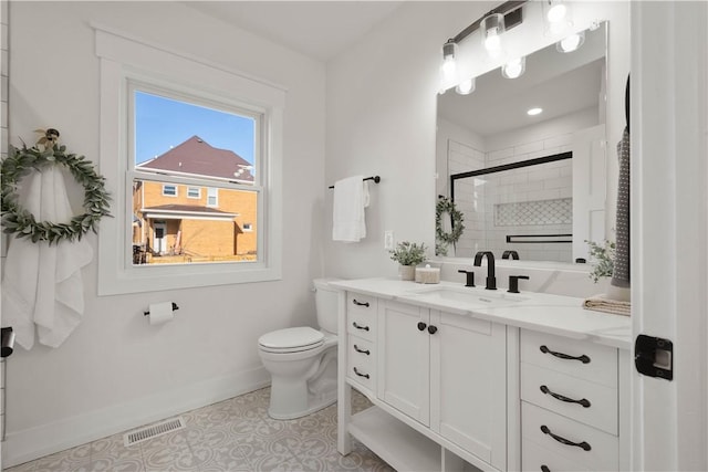 bathroom with tile patterned floors, toilet, a shower with shower door, and vanity