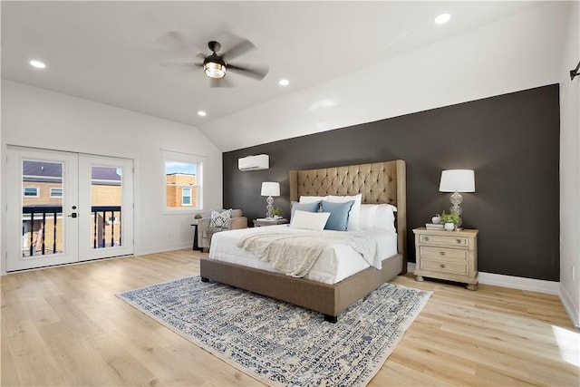 bedroom featuring lofted ceiling, access to exterior, a wall mounted AC, french doors, and light wood-type flooring