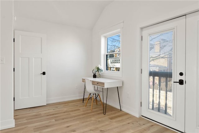 entryway featuring vaulted ceiling and light hardwood / wood-style flooring