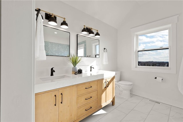 bathroom featuring lofted ceiling, vanity, and toilet