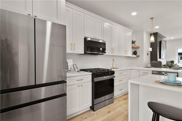 kitchen with appliances with stainless steel finishes and white cabinets