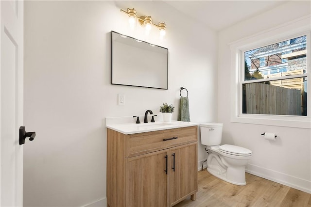 bathroom featuring vanity, hardwood / wood-style flooring, and toilet