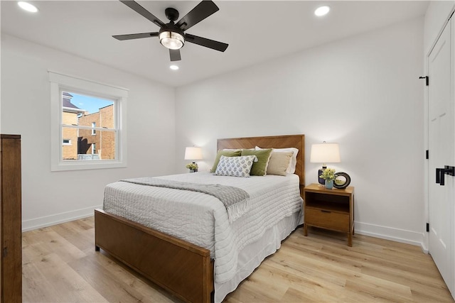 bedroom with ceiling fan and light wood-type flooring