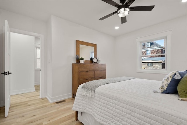 bedroom with ceiling fan and light hardwood / wood-style floors