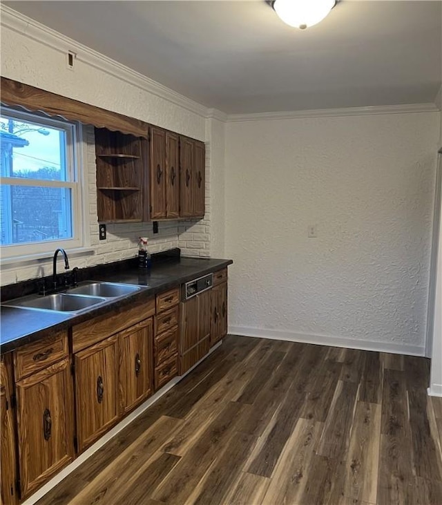 kitchen featuring dark brown cabinetry, sink, crown molding, dark hardwood / wood-style flooring, and backsplash