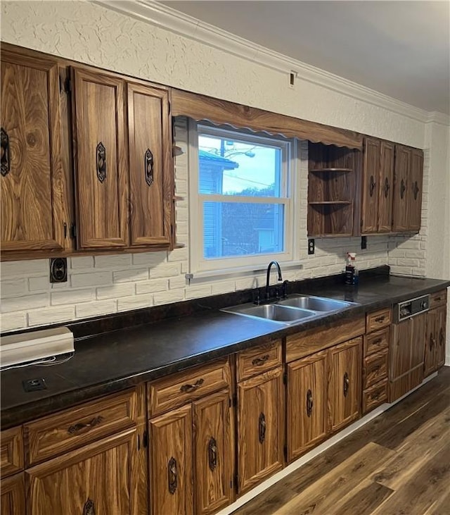 kitchen with ornamental molding, dark hardwood / wood-style flooring, sink, and backsplash