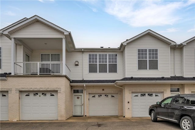 view of property featuring a balcony and a garage