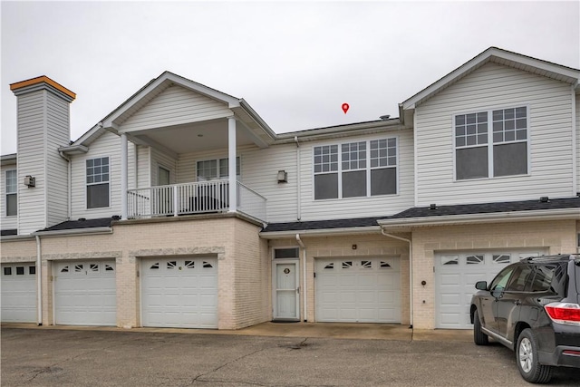 view of property featuring a balcony and a garage