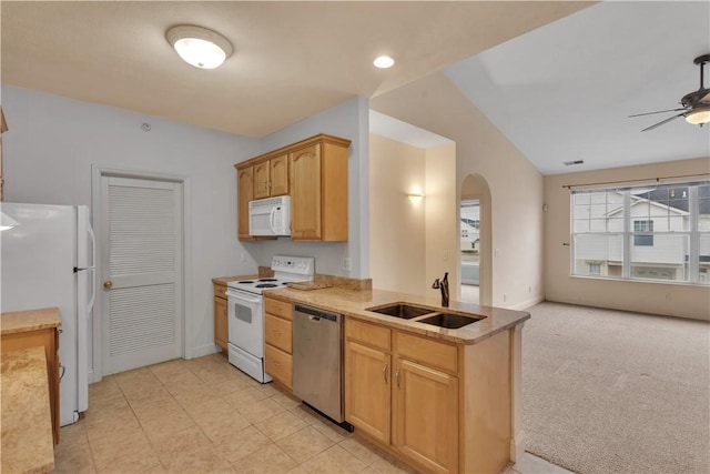 kitchen featuring light brown cabinetry, sink, light colored carpet, ceiling fan, and white appliances