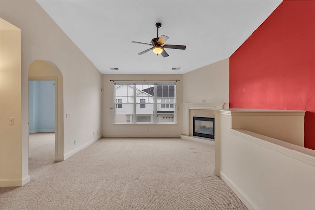 unfurnished living room with light carpet and ceiling fan