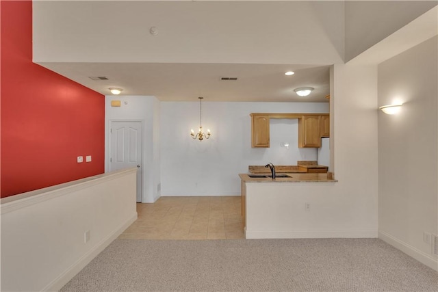 kitchen with sink, light brown cabinets, a notable chandelier, pendant lighting, and light colored carpet