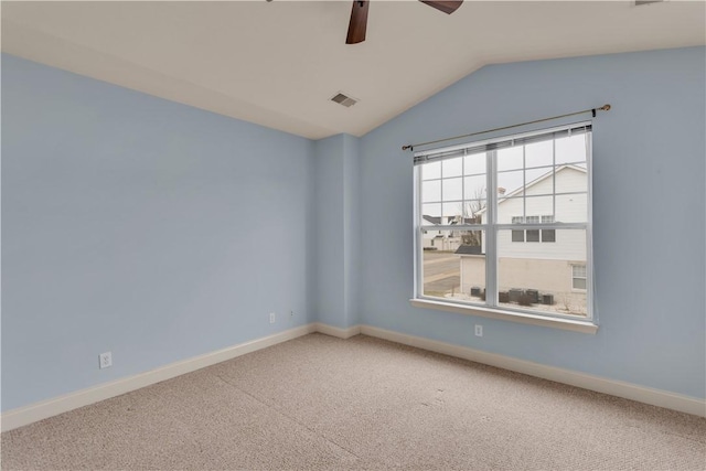 carpeted empty room featuring vaulted ceiling and ceiling fan