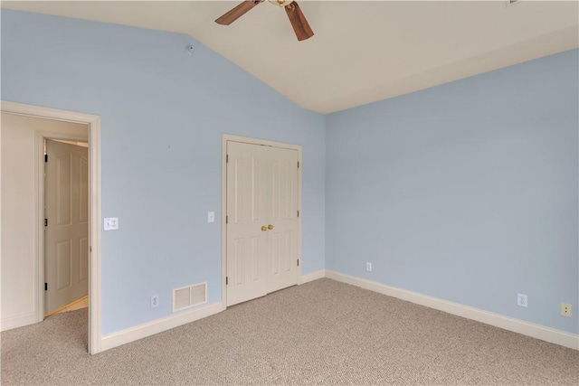 unfurnished bedroom with lofted ceiling, light carpet, ceiling fan, and a closet