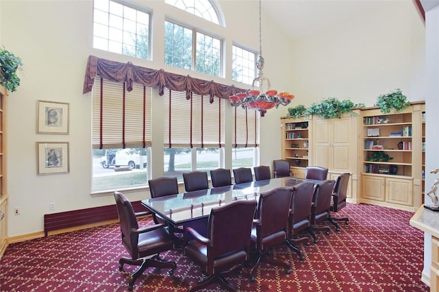 dining space featuring a high ceiling and carpet floors