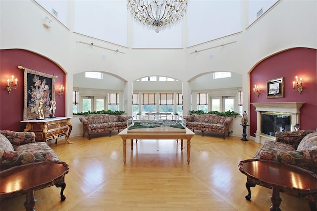 living room with an inviting chandelier, a healthy amount of sunlight, and light wood-type flooring