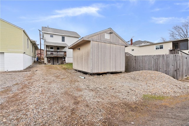 back of property with central air condition unit and a storage shed