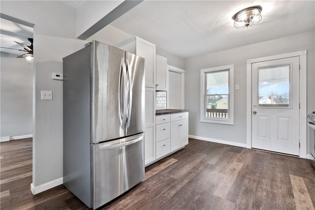 kitchen featuring stainless steel refrigerator, white cabinetry, dark hardwood / wood-style flooring, and ceiling fan