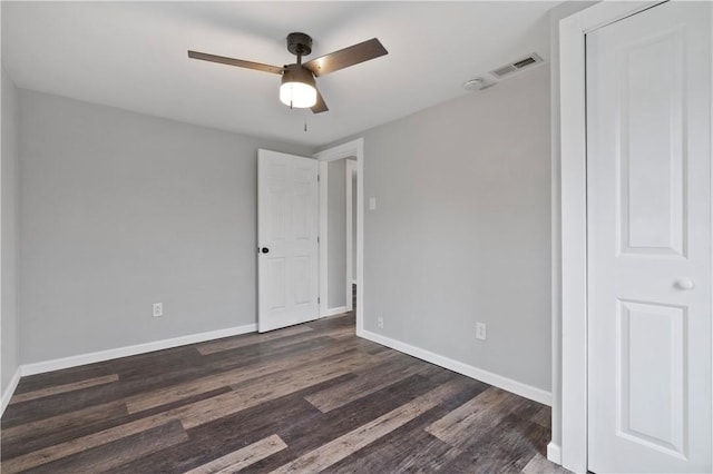 unfurnished room featuring dark hardwood / wood-style floors and ceiling fan