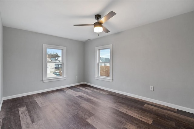 spare room with dark hardwood / wood-style floors and ceiling fan