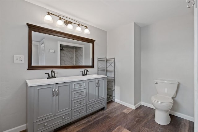 bathroom featuring vanity, wood-type flooring, and toilet