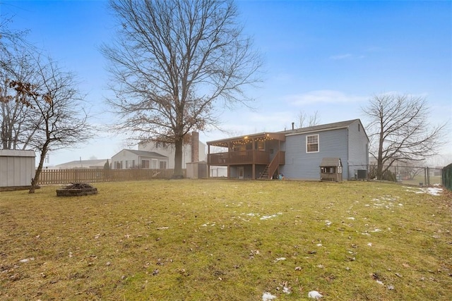 view of yard featuring a wooden deck and a fire pit