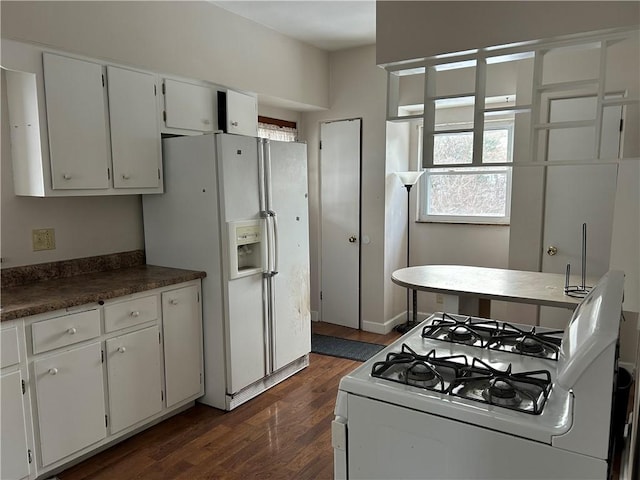 kitchen with white cabinetry, white appliances, and dark hardwood / wood-style floors