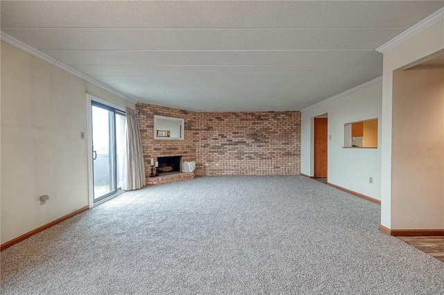 unfurnished living room with brick wall, ornamental molding, carpet floors, and a brick fireplace