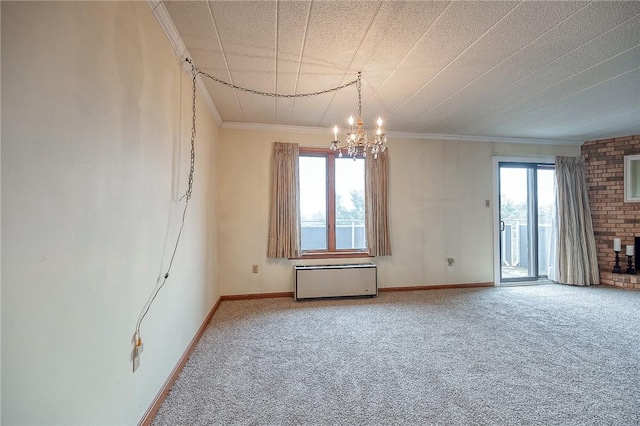 carpeted spare room with radiator, ornamental molding, and a chandelier