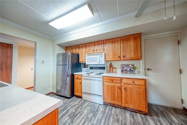 kitchen with hardwood / wood-style floors, white appliances, and ornamental molding