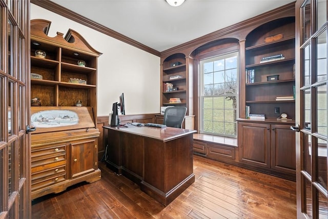 office area featuring crown molding, built in shelves, dark hardwood / wood-style floors, and french doors