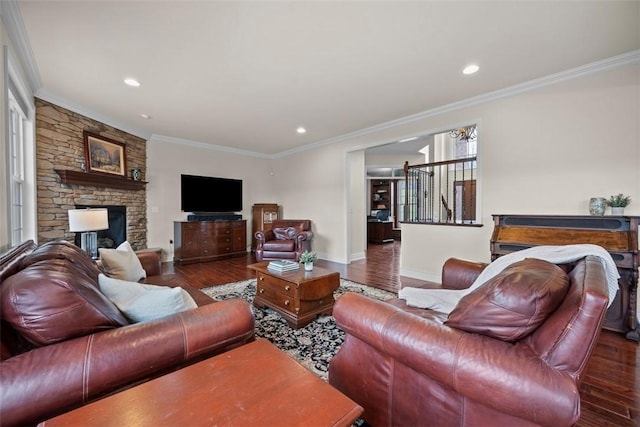 living room with ornamental molding, dark hardwood / wood-style flooring, and a stone fireplace