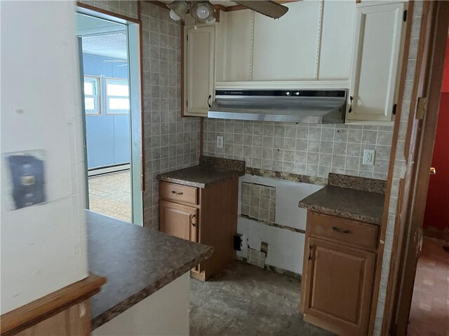 kitchen featuring tile walls, decorative backsplash, and a baseboard radiator