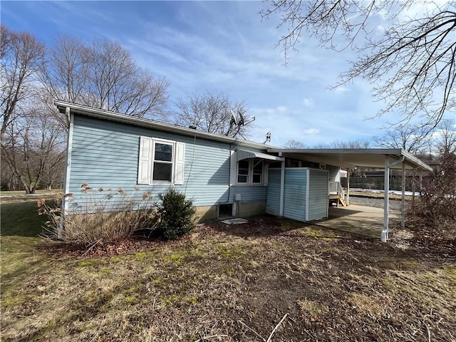 rear view of property with a carport