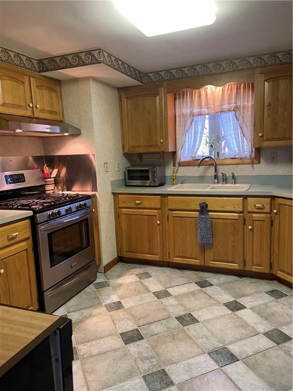 kitchen featuring gas range and sink