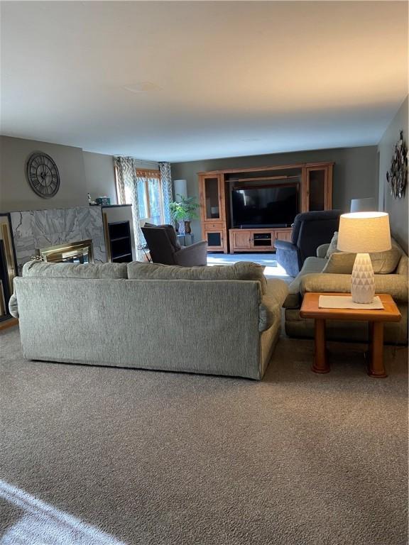 living room featuring carpet flooring and a fireplace