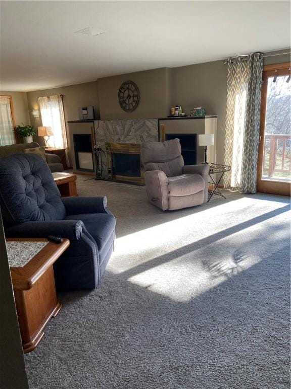 carpeted living room featuring a fireplace