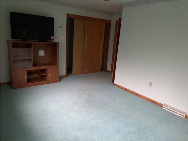 unfurnished living room with light colored carpet