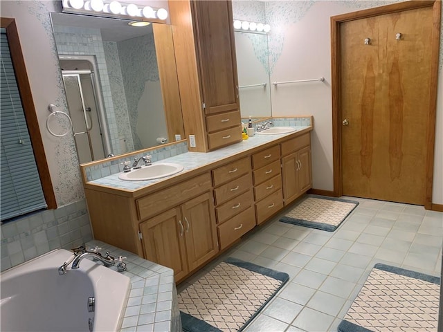 bathroom featuring tile patterned flooring, vanity, and plus walk in shower