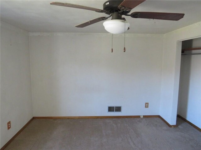 carpeted spare room with ceiling fan