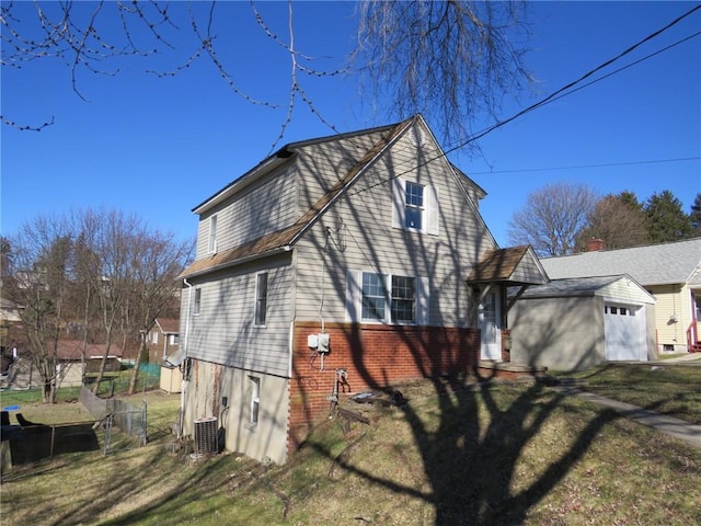 view of home's exterior featuring central AC unit and a lawn