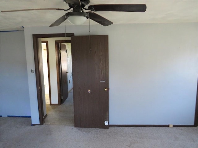 spare room featuring ceiling fan and light colored carpet