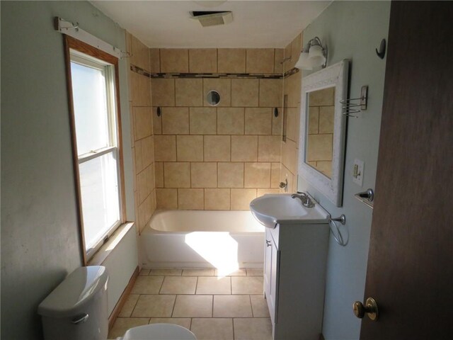 full bathroom with vanity, plenty of natural light, tile patterned floors, and toilet