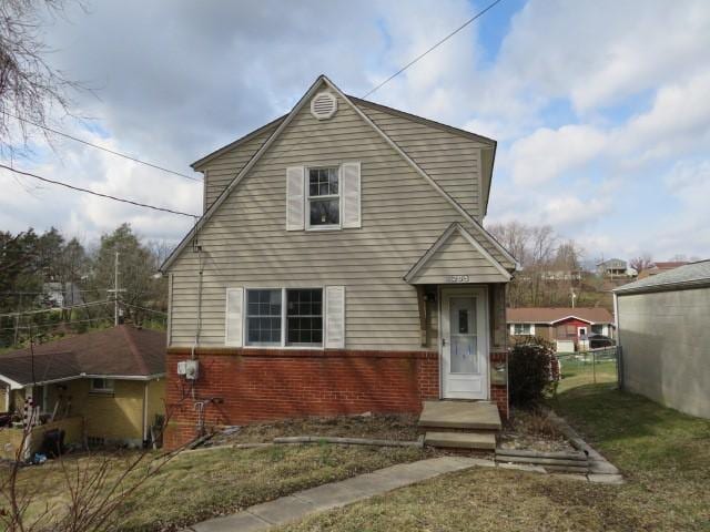 view of front of property with brick siding and fence