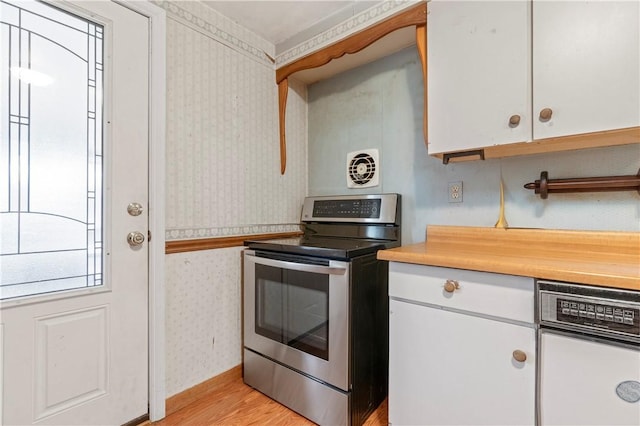 kitchen featuring stainless steel electric range, light hardwood / wood-style flooring, and white cabinets