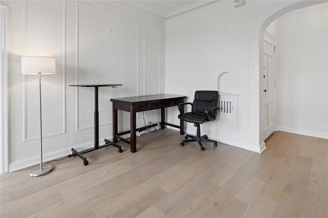 office featuring ornamental molding and light hardwood / wood-style floors