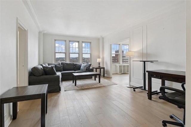 living room featuring crown molding and light hardwood / wood-style floors