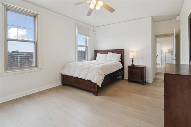 bedroom with ceiling fan and light hardwood / wood-style floors