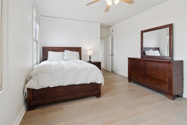 bedroom featuring ceiling fan, vaulted ceiling, and light wood-type flooring